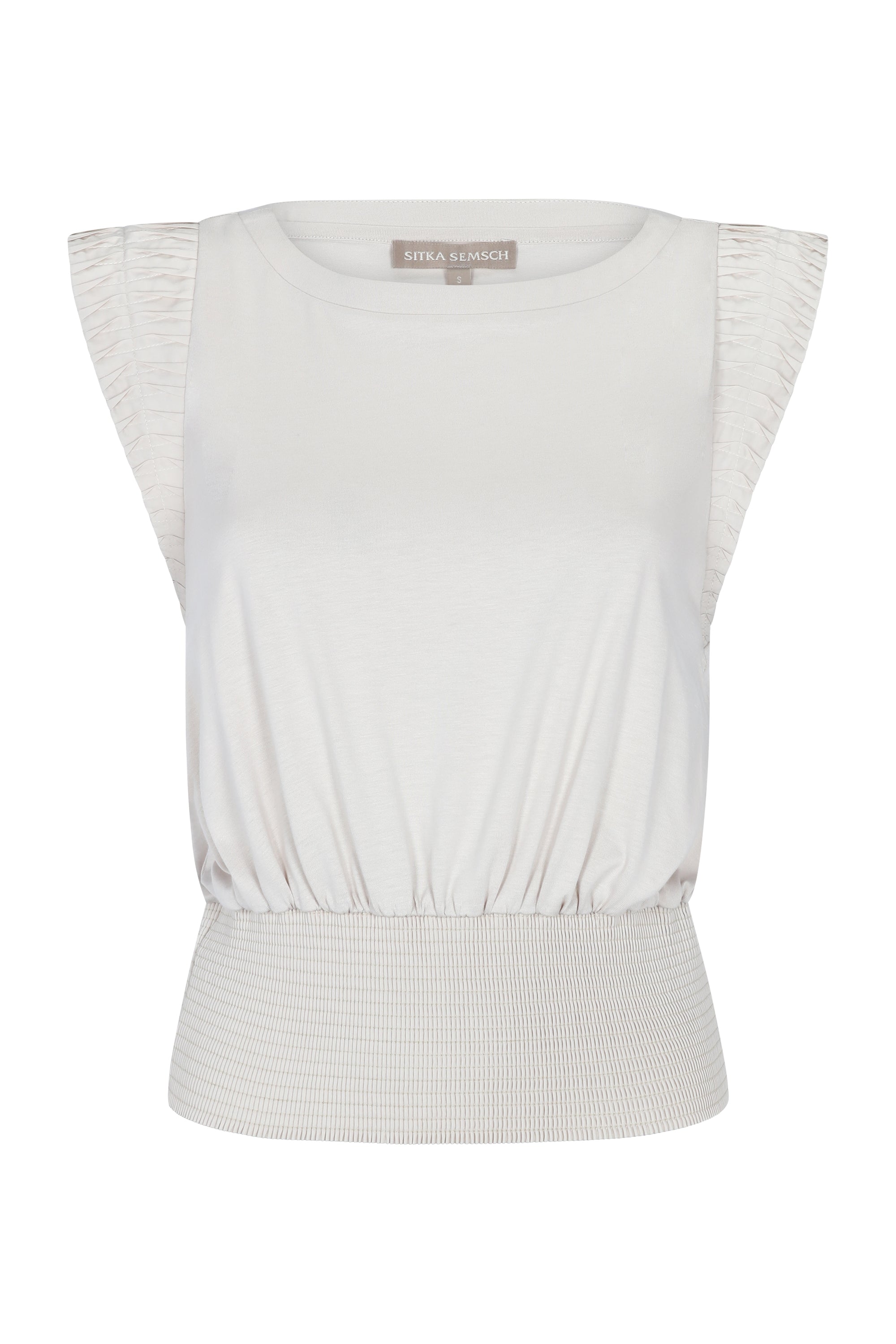 Selena Top crafted from 100% cotton, featuring a round neckline, semi-ruffled sleeveless design, and an elasticized waistband.