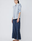 Side profile of the Bobi Blouse, highlighting the delicate ruffle detail cascading over the shoulder.