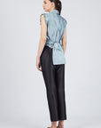 Eijan satin blouse in light blue, lavender, and magenta with pleated shoulder details and waist knot