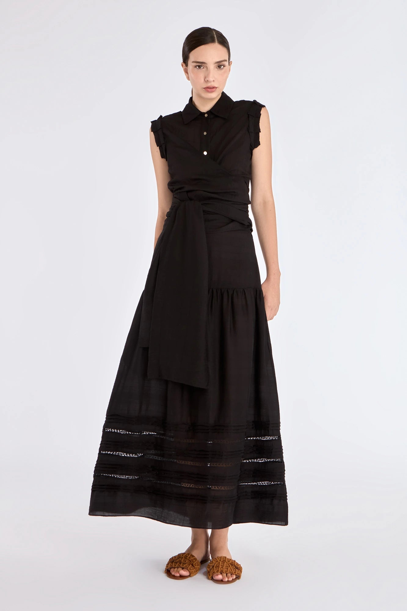 A sophisticated look featuring the black sleeveless Harlow Blouse with its tailored collar.