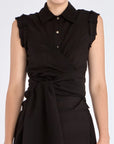 The Harlow Wrap Blouse in black, detailed with its polished metal buttons.