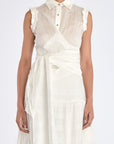 Model wearing the Harlow Wrap Blouse in Off White, showcasing the structured collar and metal button detail.