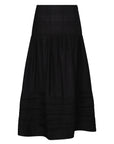 The Luanda Skirt in black, styled to showcase its high-waist fit and voluminous midi silhouette.
