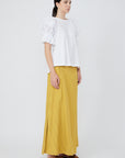 Nery top crafted from cotton knit and woven poplin, featuring a round neckline, short balloon sleeves with elastic, and a relaxed silhouette.