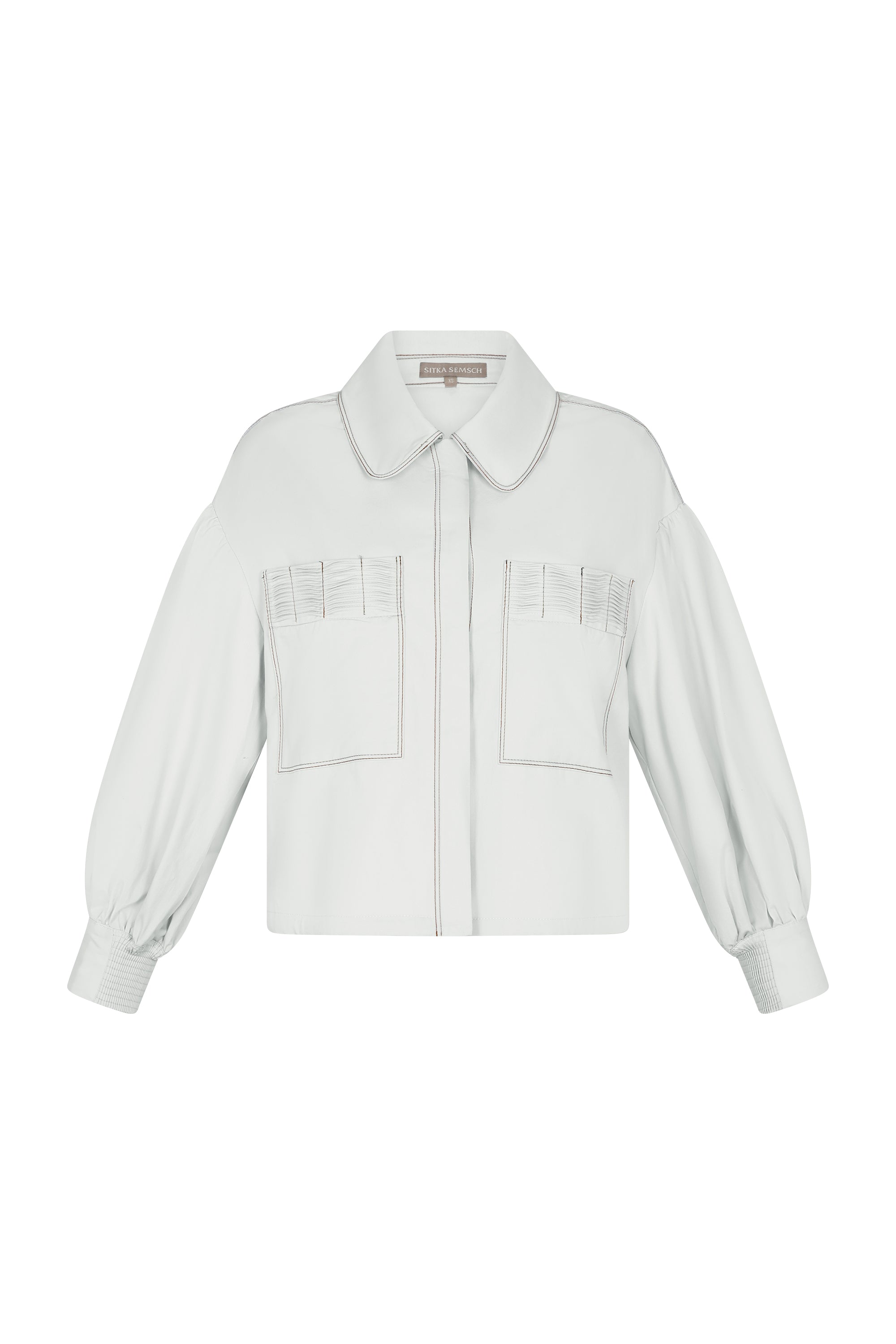 Gwen Jacket in Off White – Cropped cotton jacket with front pleats, shirt collar, and patch pockets.