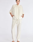 The Ailani Jacket in Off White, highlighting its clean architectural lines and drawstring detail.