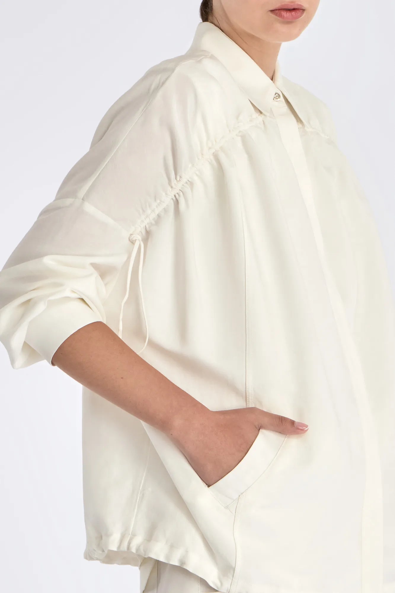 Detail shot of the polished metal button and linen blend texture on the Off White Ailani Jacket.