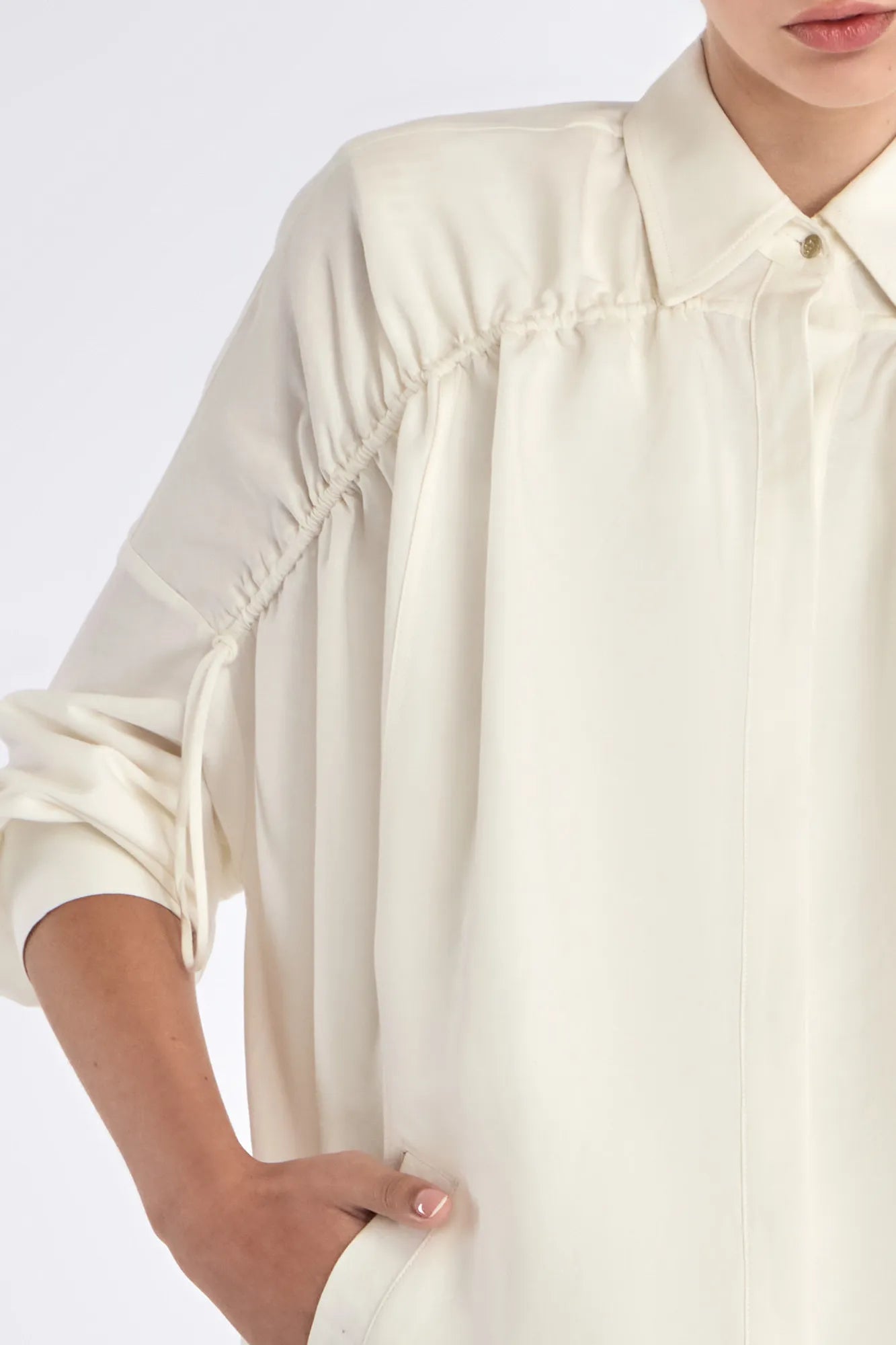 Detail shot of the polished metal button and linen blend texture on the Off White Ailani Jacket.