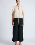 Aliana high-waisted palazzo pants in 100% cotton, featuring front and back patch pockets, side vents with button details, and contrast stitching.