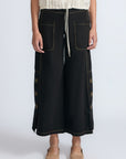 Aliana high-waisted palazzo pants in 100% cotton, featuring front and back patch pockets, side vents with button details, and contrast stitching.
