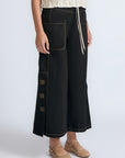 Aliana high-waisted palazzo pants in 100% cotton, featuring front and back patch pockets, side vents with button details, and contrast stitching.