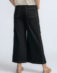 Aliana high-waisted palazzo pants in 100% cotton, featuring front and back patch pockets, side vents with button details, and contrast stitching.