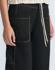Aliana high-waisted palazzo pants in 100% cotton, featuring front and back patch pockets, side vents with button details, and contrast stitching.