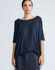 Amaya Top in Navy – Casual-chic cotton top with asymmetrical hem and hem pullers for versatile styling.