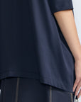 Amaya Top in Navy – Casual-chic cotton top with asymmetrical hem and hem pullers for versatile styling.