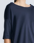 Amaya Top in Navy – Casual-chic cotton top with asymmetrical hem and hem pullers for versatile styling.
