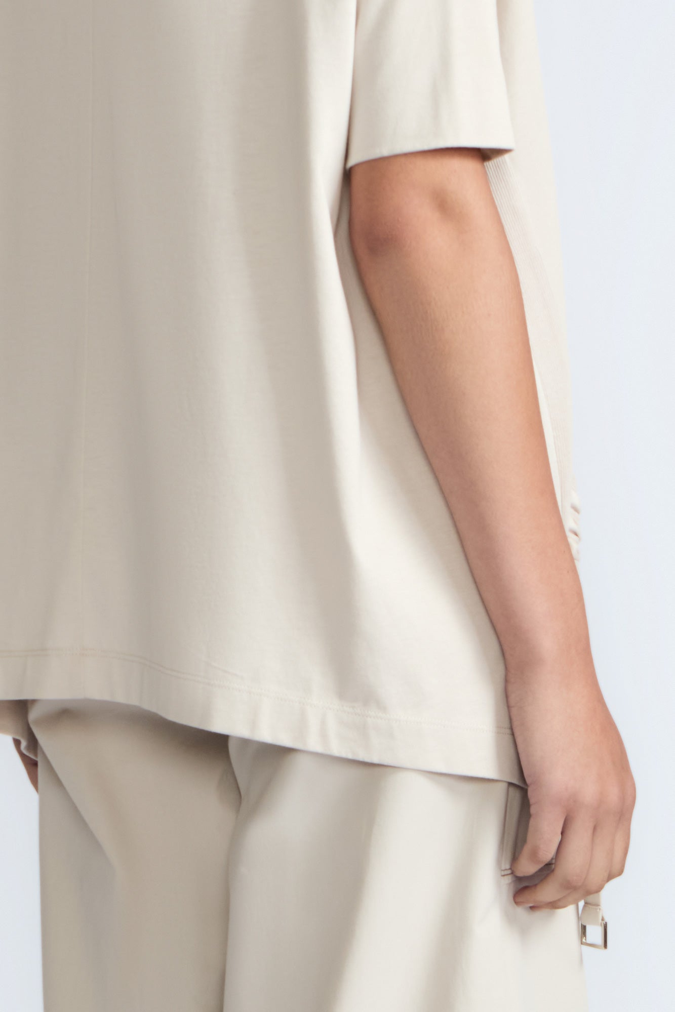 Amaya Top in Prestine – Cotton short-sleeve top with asymmetric hemline and metal-tipped buckle drawstrings.