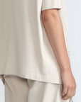 Amaya Top in Prestine – Cotton short-sleeve top with asymmetric hemline and metal-tipped buckle drawstrings.