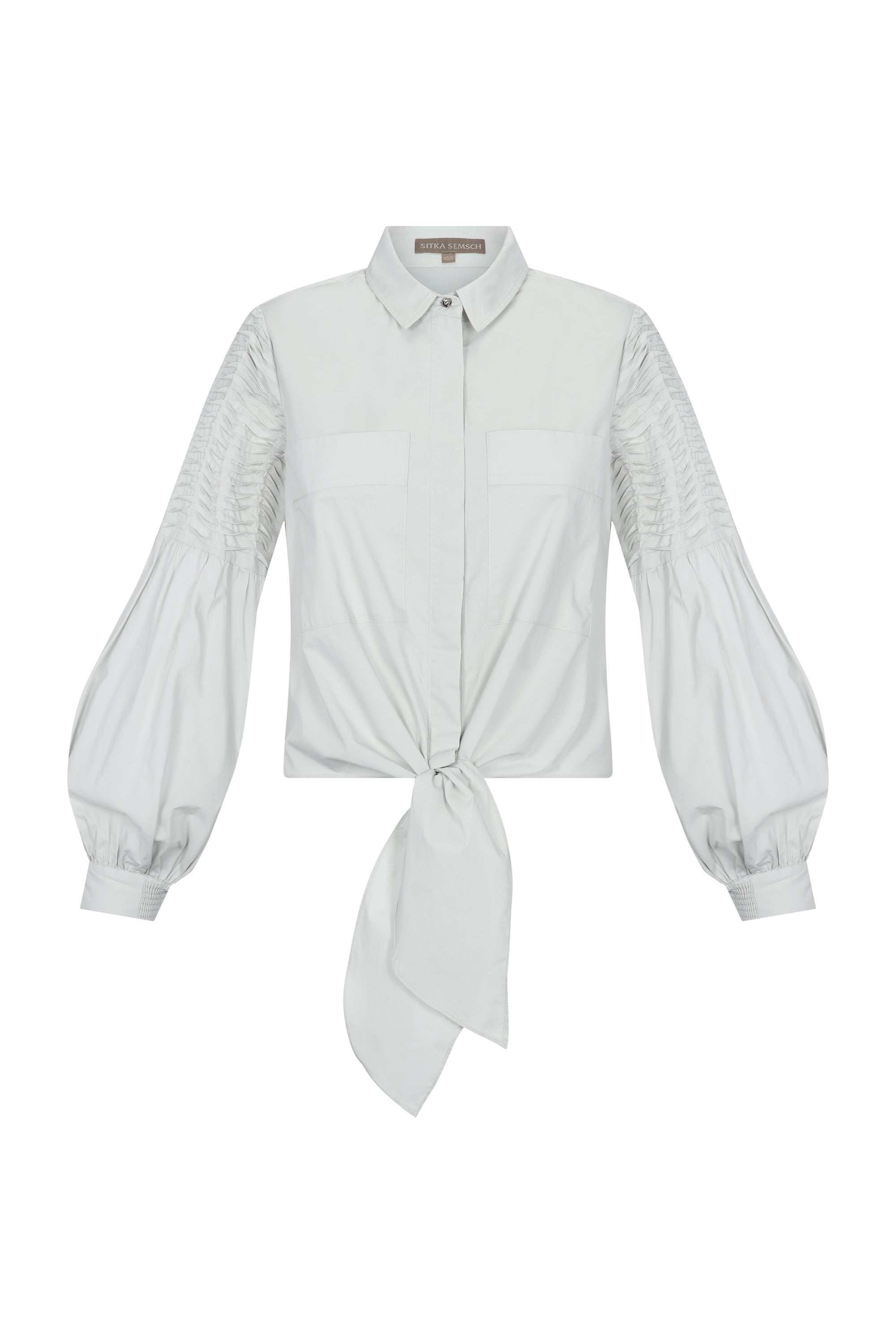 Ansley Blouse in Silver – Boho-inspired cotton blouse with patch pockets, balloon sleeves, and front tie.