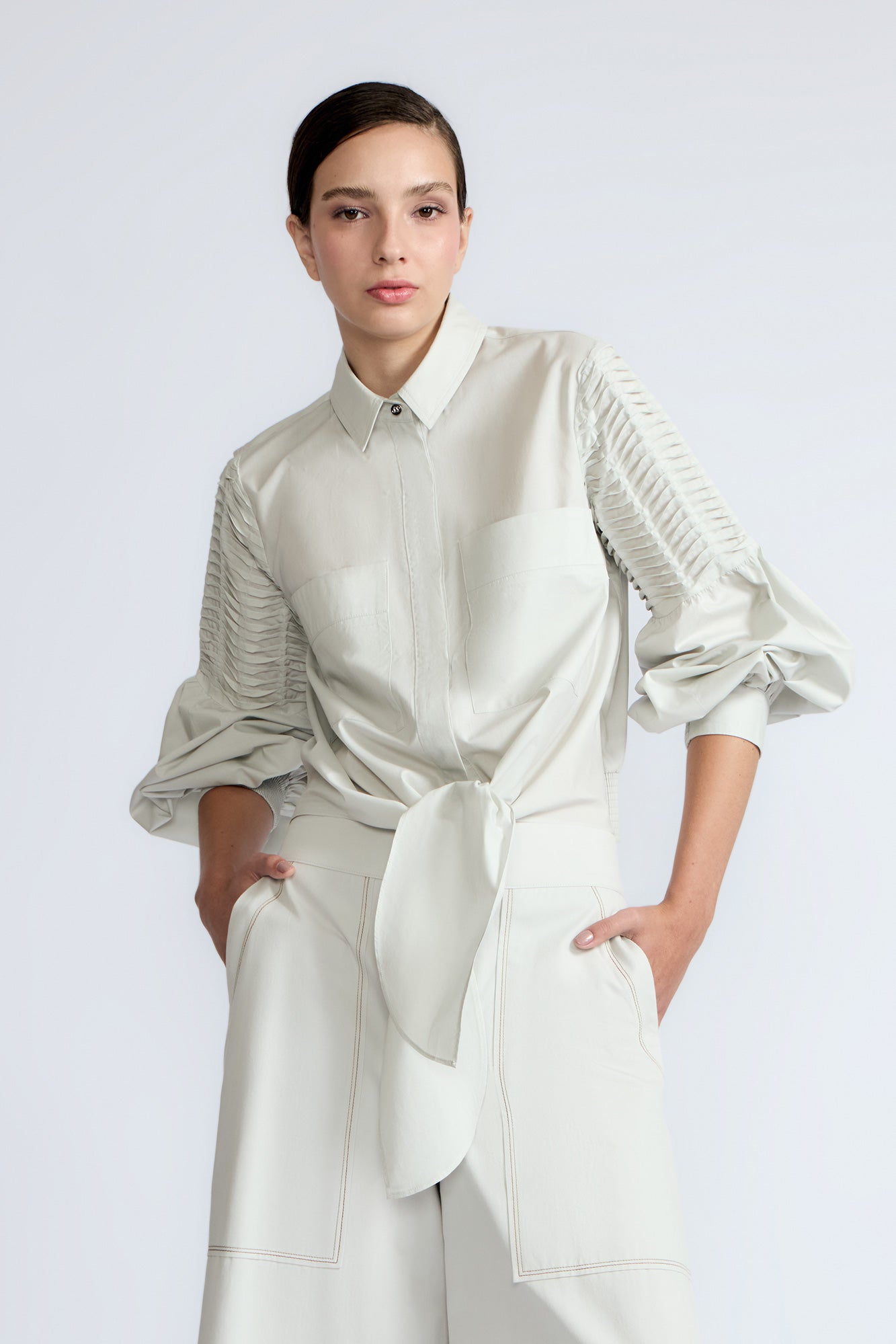 Ansley Blouse in Silver – Boho-inspired cotton blouse with patch pockets, balloon sleeves, and front tie.
