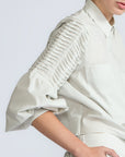 Ansley Blouse in Silver – Boho-inspired cotton blouse with patch pockets, balloon sleeves, and front tie.