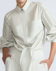 Ansley Blouse in Silver – Boho-inspired cotton blouse with patch pockets, balloon sleeves, and front tie.