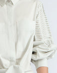 Ansley Blouse in Silver – Boho-inspired cotton blouse with patch pockets, balloon sleeves, and front tie.