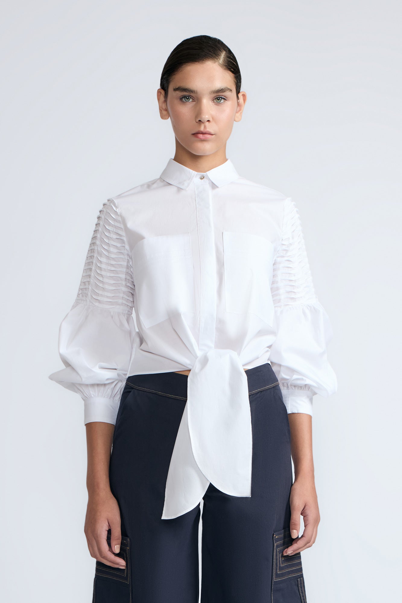 Ansley Blouse in White – Relaxed-fit cotton blouse with shirt collar, button front, and tied waist detail.