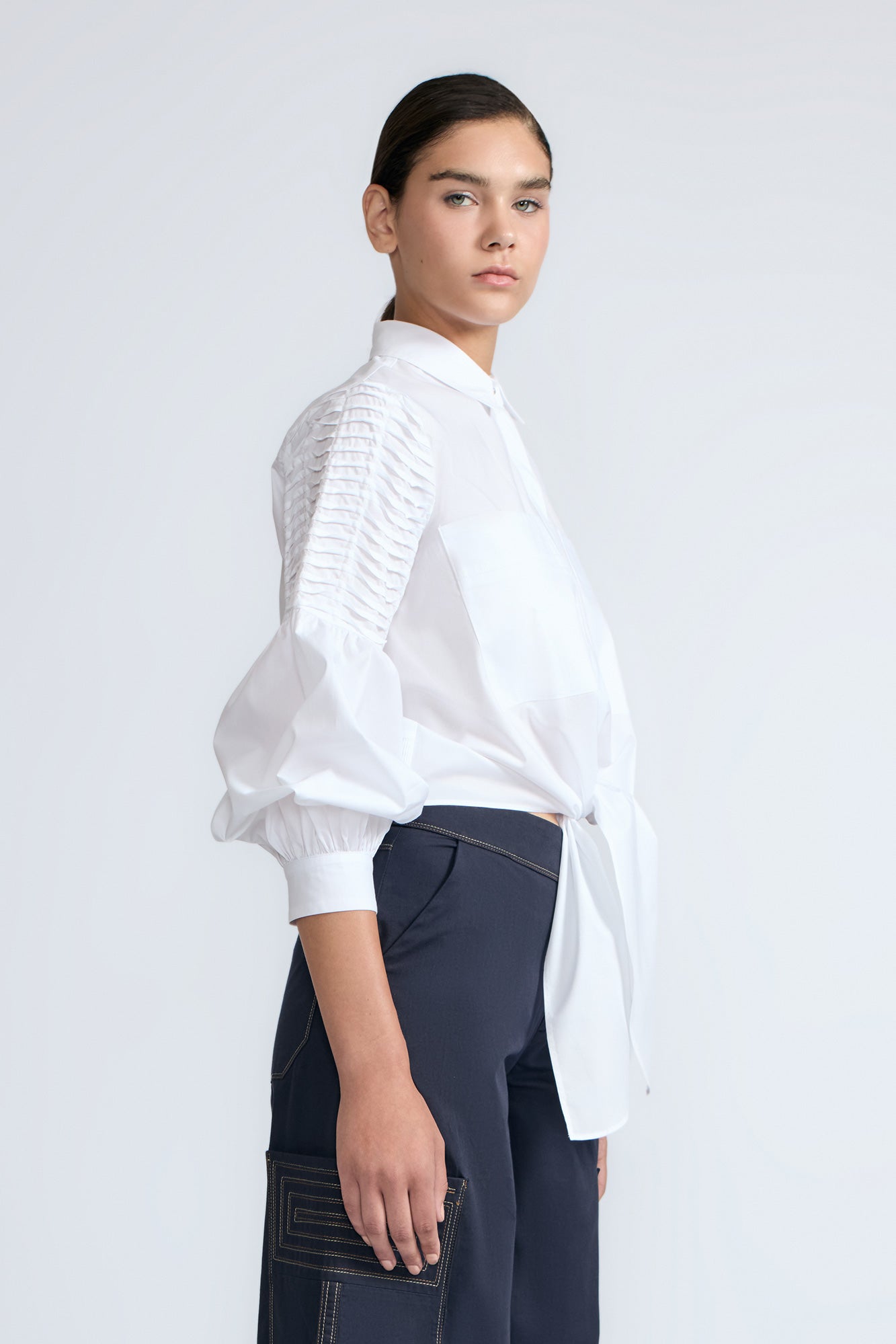 Ansley Blouse in White – Relaxed-fit cotton blouse with shirt collar, button front, and tied waist detail.