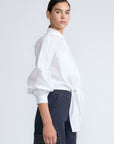 Ansley Blouse in White – Relaxed-fit cotton blouse with shirt collar, button front, and tied waist detail.