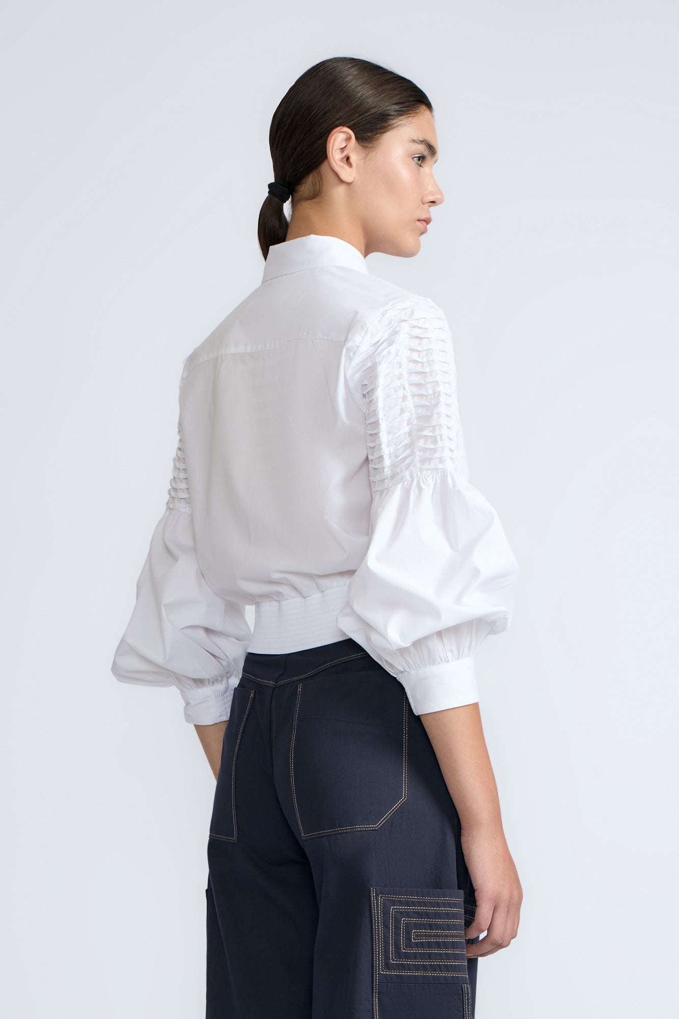 Ansley Blouse in White – Relaxed-fit cotton blouse with shirt collar, button front, and tied waist detail.