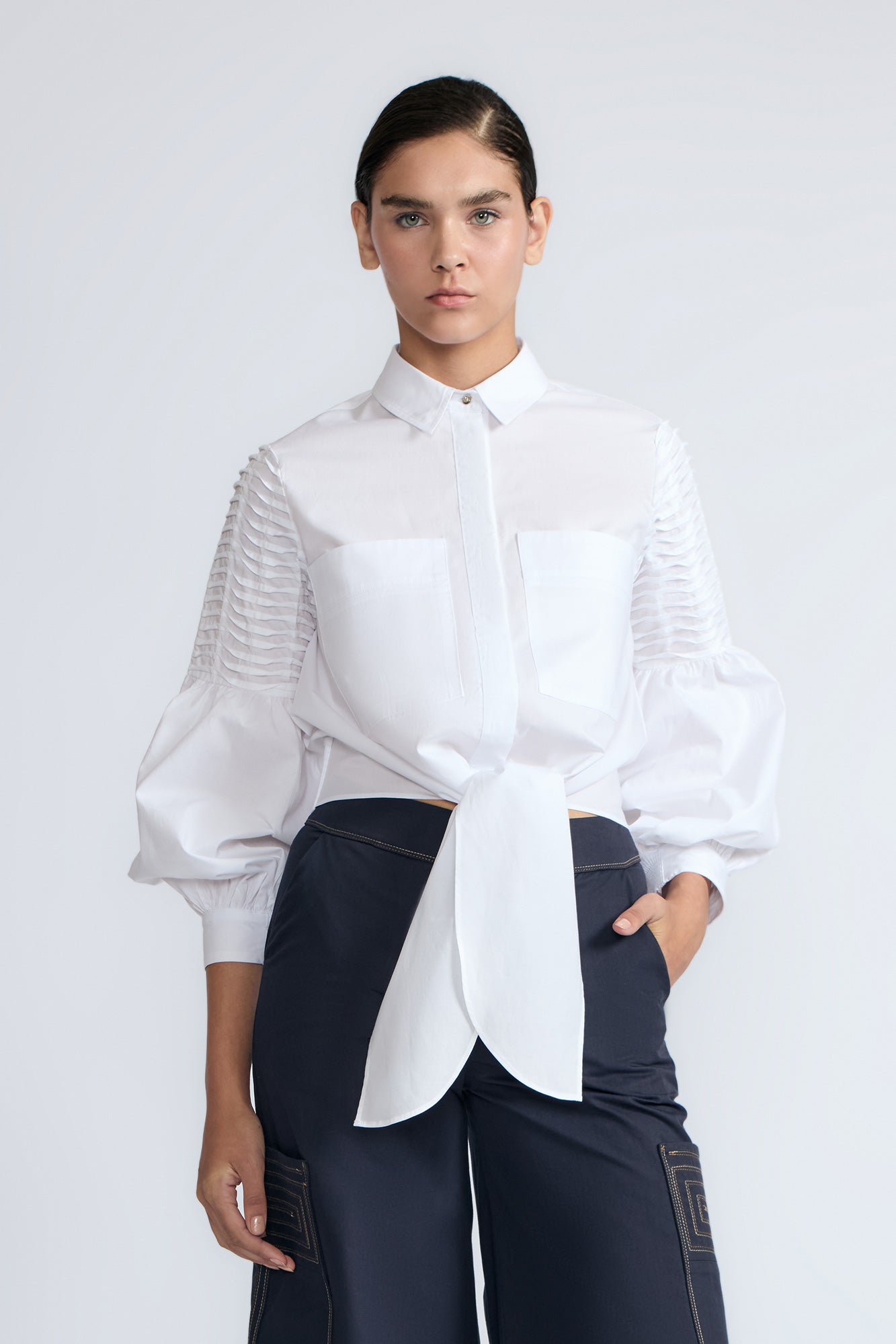 Ansley Blouse in White – Relaxed-fit cotton blouse with shirt collar, button front, and tied waist detail.