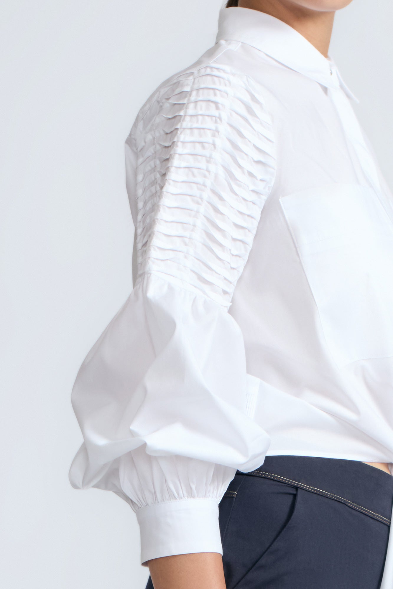 Ansley Blouse in White – Relaxed-fit cotton blouse with shirt collar, button front, and tied waist detail.