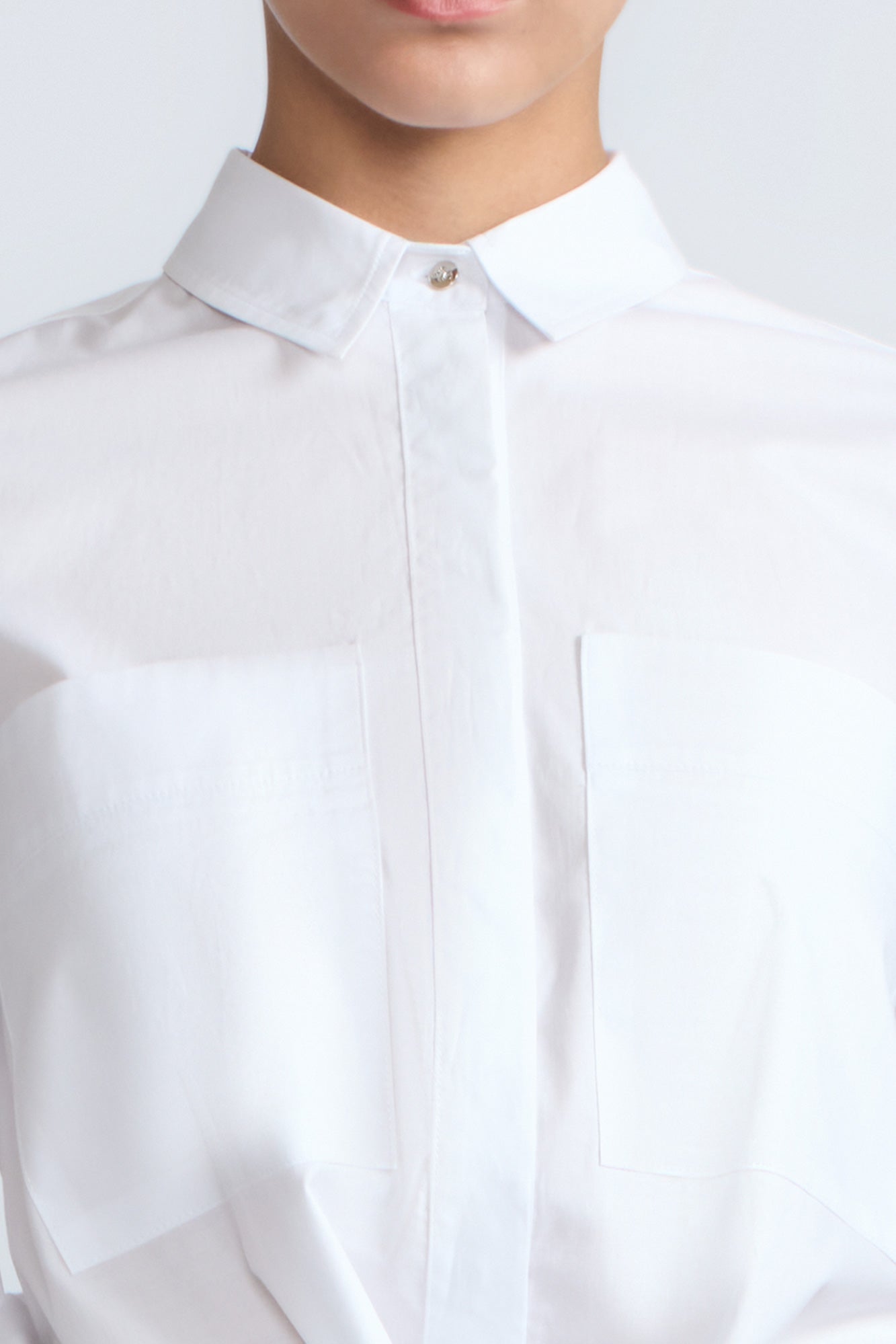 Ansley Blouse in White – Relaxed-fit cotton blouse with shirt collar, button front, and tied waist detail.