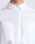 Ansley Blouse in White – Relaxed-fit cotton blouse with shirt collar, button front, and tied waist detail.