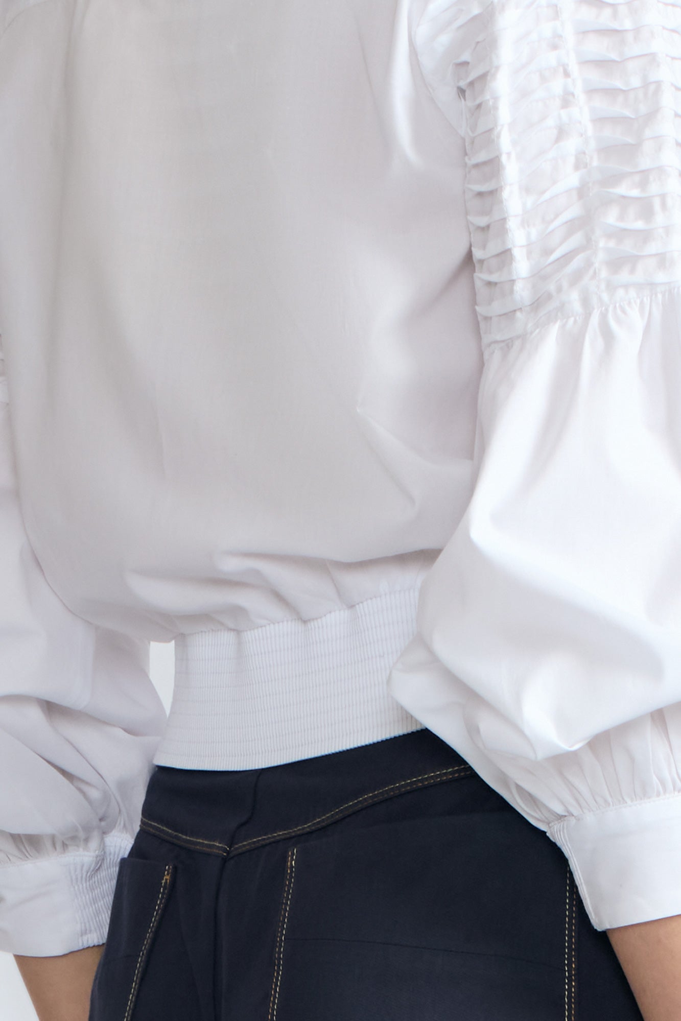 Ansley Blouse in White – Relaxed-fit cotton blouse with shirt collar, button front, and tied waist detail.
