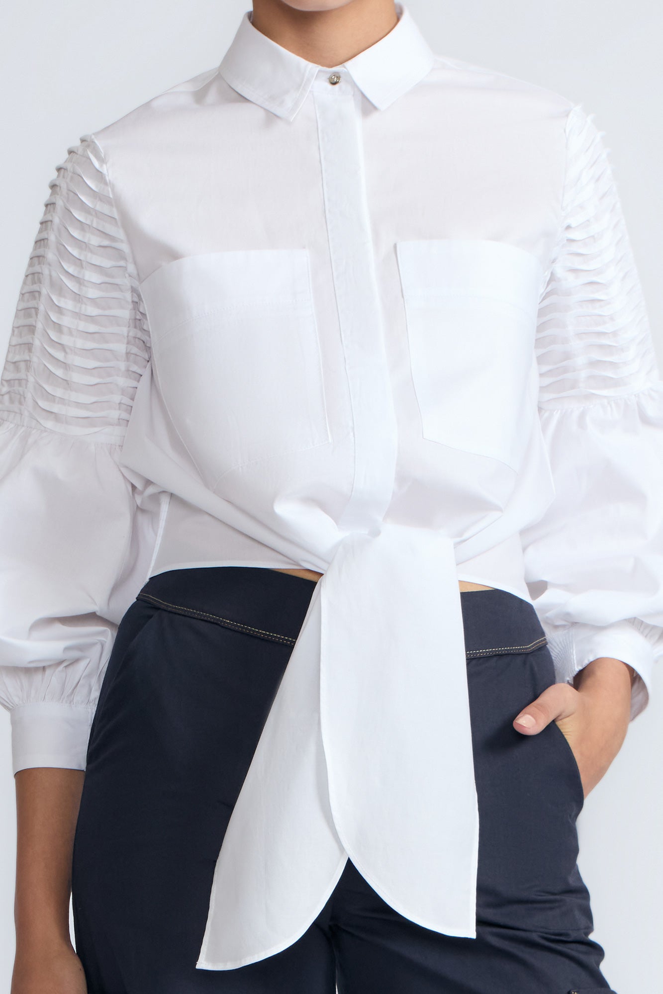 Ansley Blouse in White – Relaxed-fit cotton blouse with shirt collar, button front, and tied waist detail.