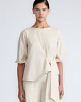 Artemisa Top in Prestine – 100% cotton top with round neckline, wrap tie at the waist, and ¾ sleeves.