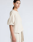 Artemisa Top in Prestine – 100% cotton top with round neckline, wrap tie at the waist, and ¾ sleeves.