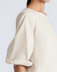 Artemisa Top in Prestine – 100% cotton top with round neckline, wrap tie at the waist, and ¾ sleeves.