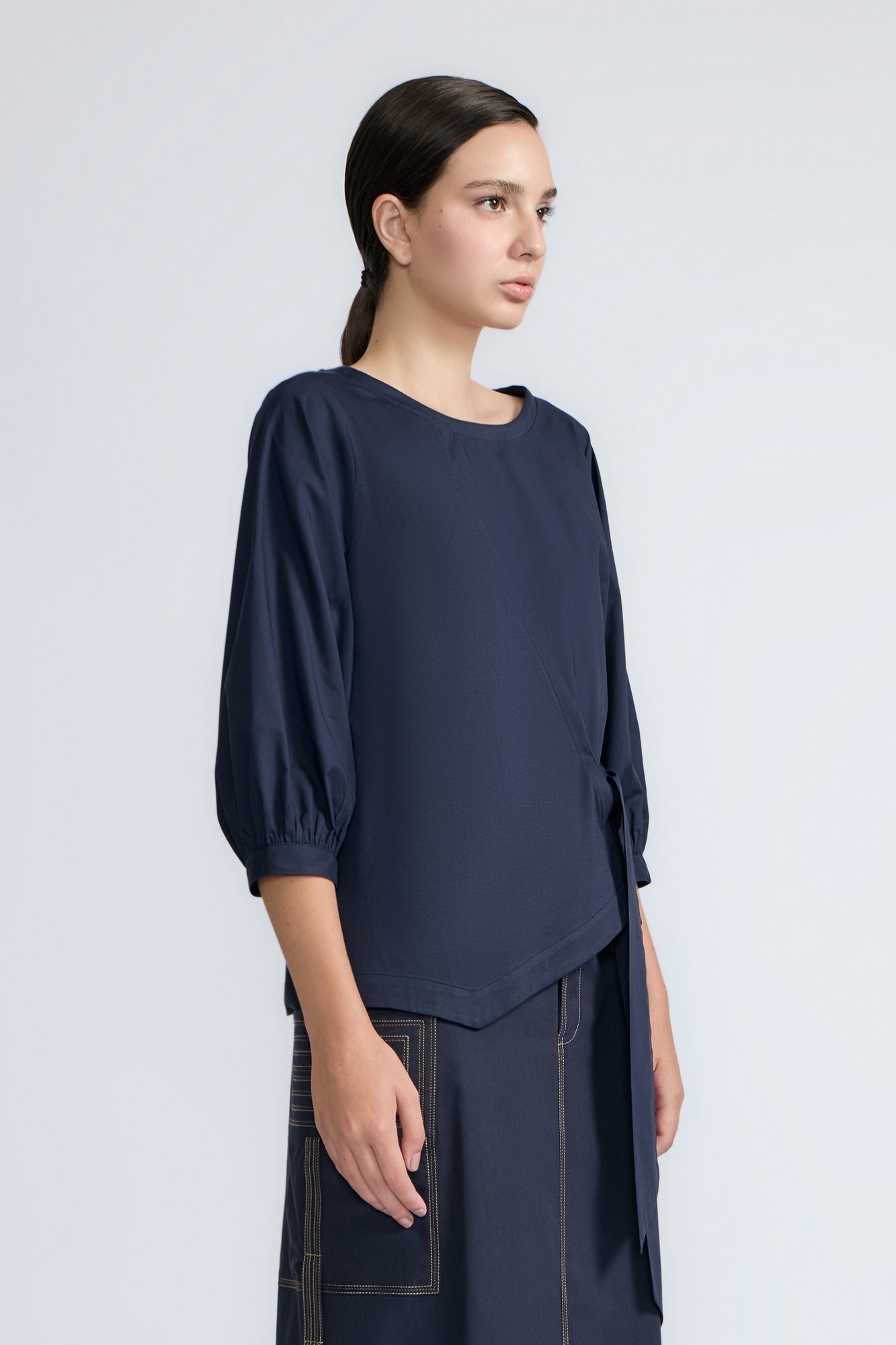 Artemisa Top in Navy – Cotton wrap top with round neckline, ¾ sleeves, and tie waist, made in Peru.
