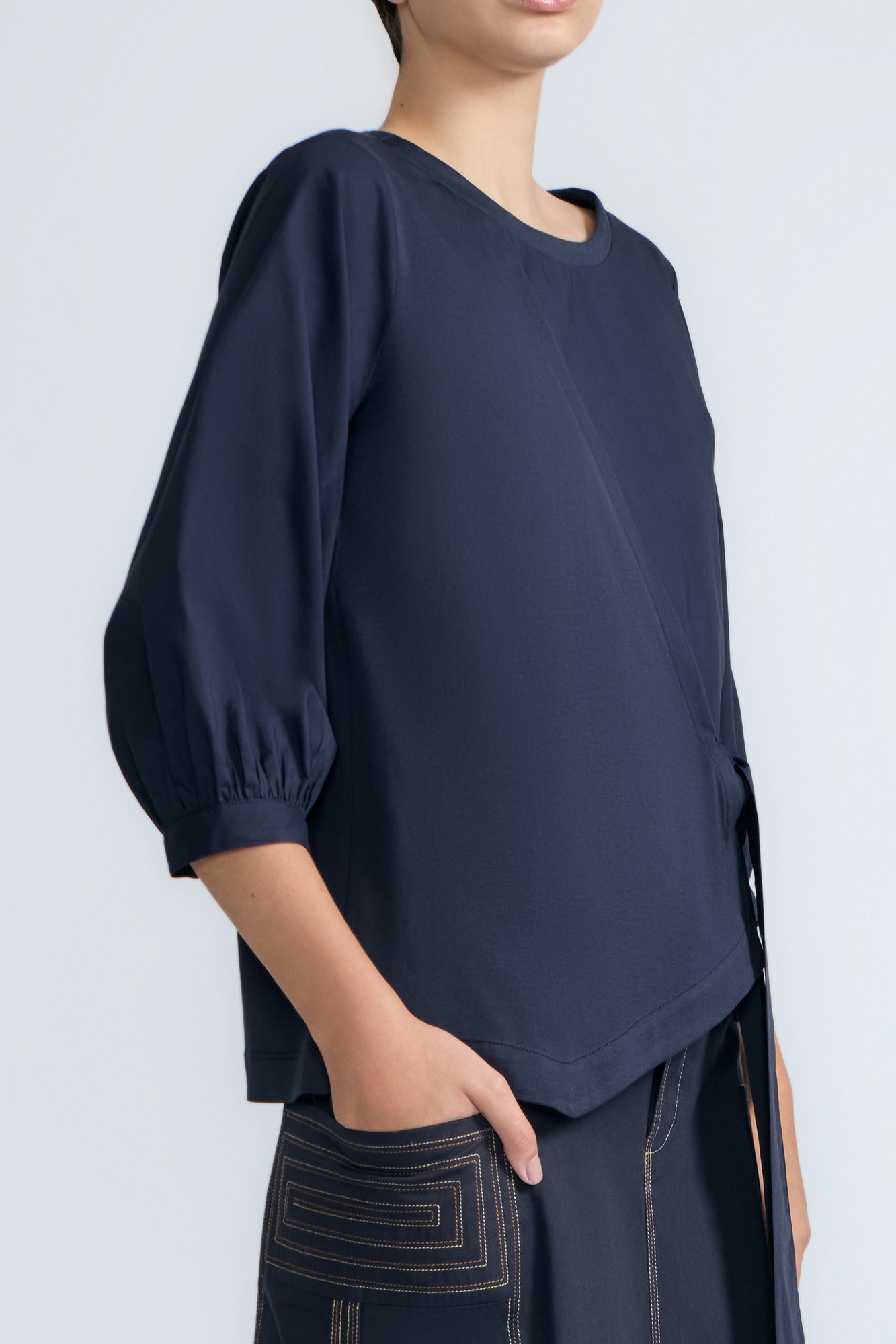 Artemisa Top in Navy – Cotton wrap top with round neckline, ¾ sleeves, and tie waist, made in Peru.