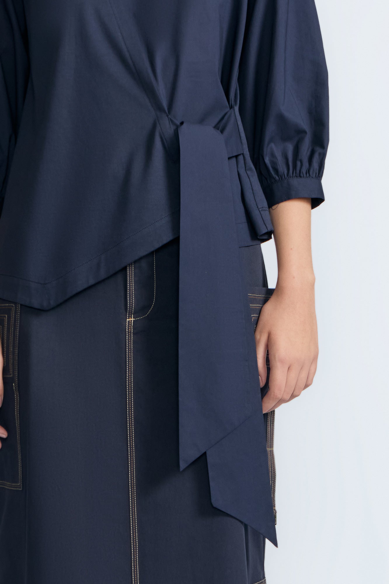 Artemisa Top in Navy – Cotton wrap top with round neckline, ¾ sleeves, and tie waist, made in Peru.