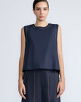 Avayah Top in Navy – 100% cotton sleeveless top with round neckline, shoulder button accents, and drawstring hem.