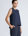Avayah Top in Navy – 100% cotton sleeveless top with round neckline, shoulder button accents, and drawstring hem.