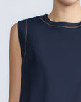 Avayah Top in Navy – 100% cotton sleeveless top with round neckline, shoulder button accents, and drawstring hem.
