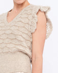 Close-up of the exquisite, handcrafted crochet openwork on the ruffle sleeve of the Beige Melange Beca Vest.
