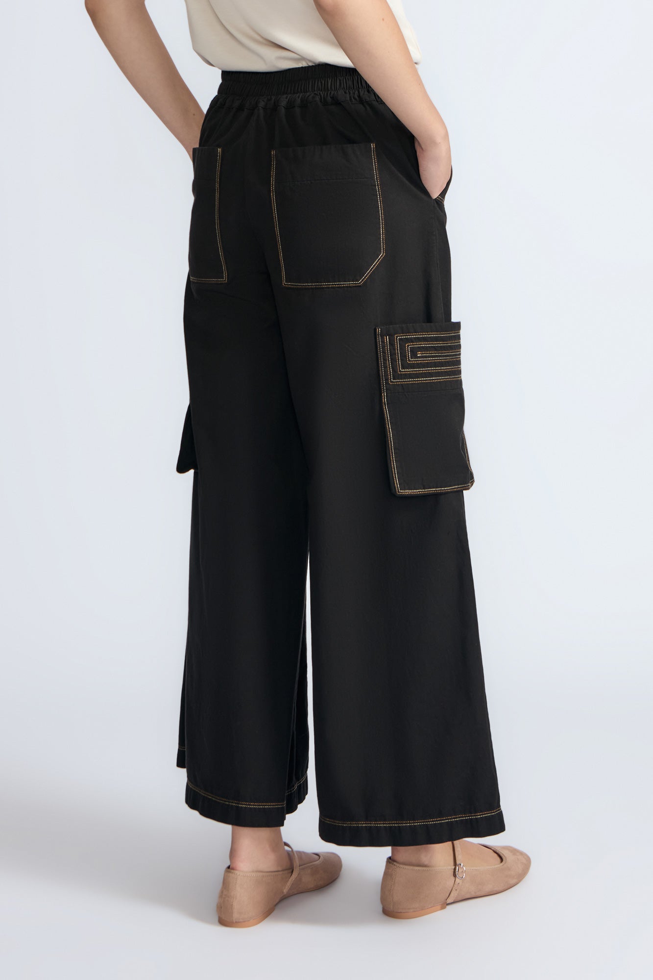 Bela Pant in Black – Cropped cotton palazzo pants with side flap pockets, elasticated waist, and contrast stitching.