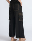 Bela Pant in Black – Cropped cotton palazzo pants with side flap pockets, elasticated waist, and contrast stitching.