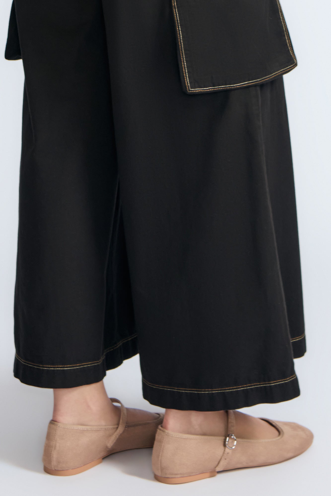 Bela Pant in Black – Cropped cotton palazzo pants with side flap pockets, elasticated waist, and contrast stitching.